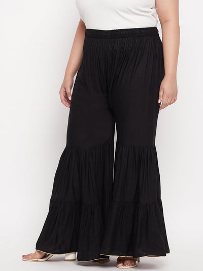 Black solid rayon flared gharara with elasticated waistband and drawstring.