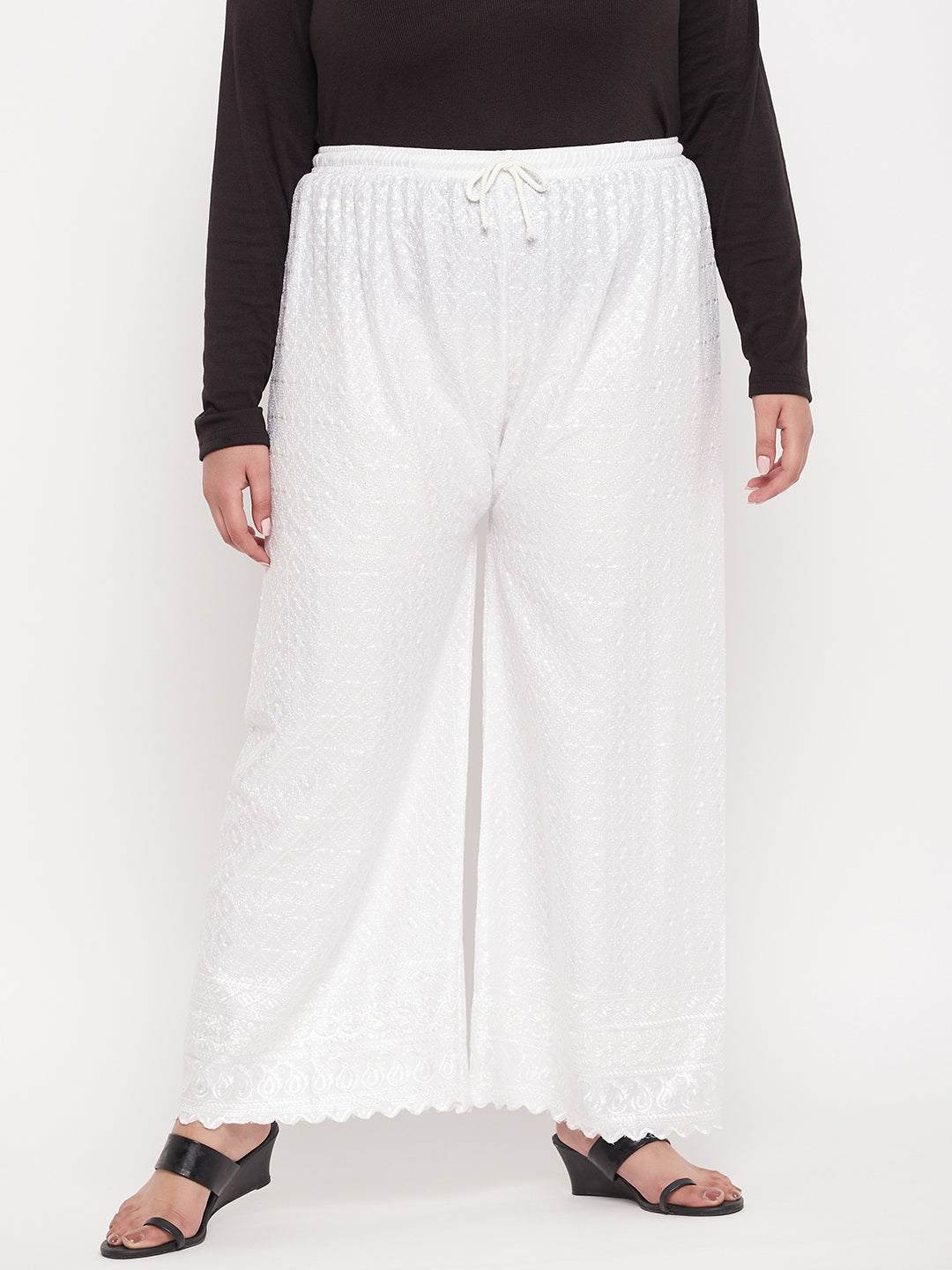 White embroidered rayon palazzo with elasticated waistband and drawstring.