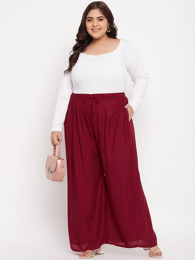 Maroon solid rayon jumbo sharara with elasticated waistband and drawstring.