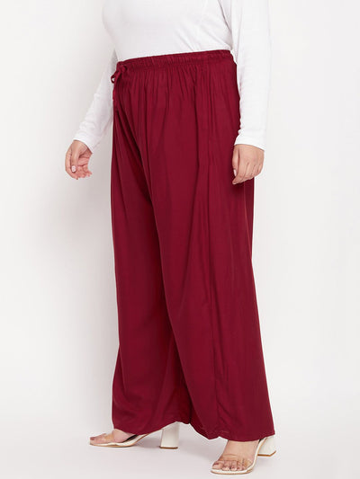 Maroon solid rayon jumbo sharara with elasticated waistband and drawstring.