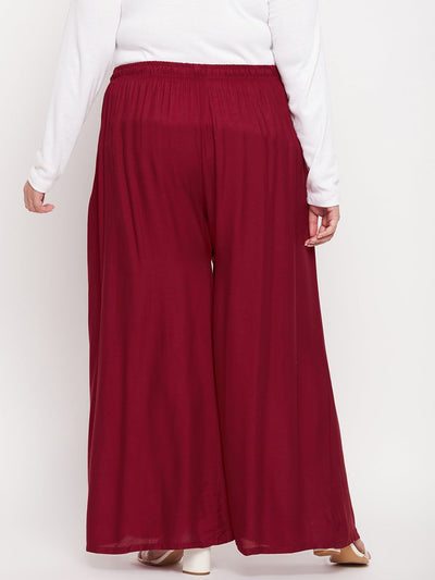 Maroon solid rayon jumbo sharara with elasticated waistband and drawstring.