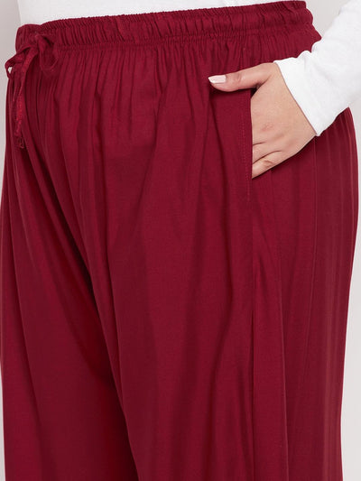 Maroon solid rayon jumbo sharara with elasticated waistband and drawstring.