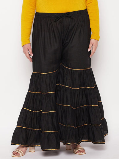 Black solid cotton flared Gharara with elasticated waistband and drawstring.
