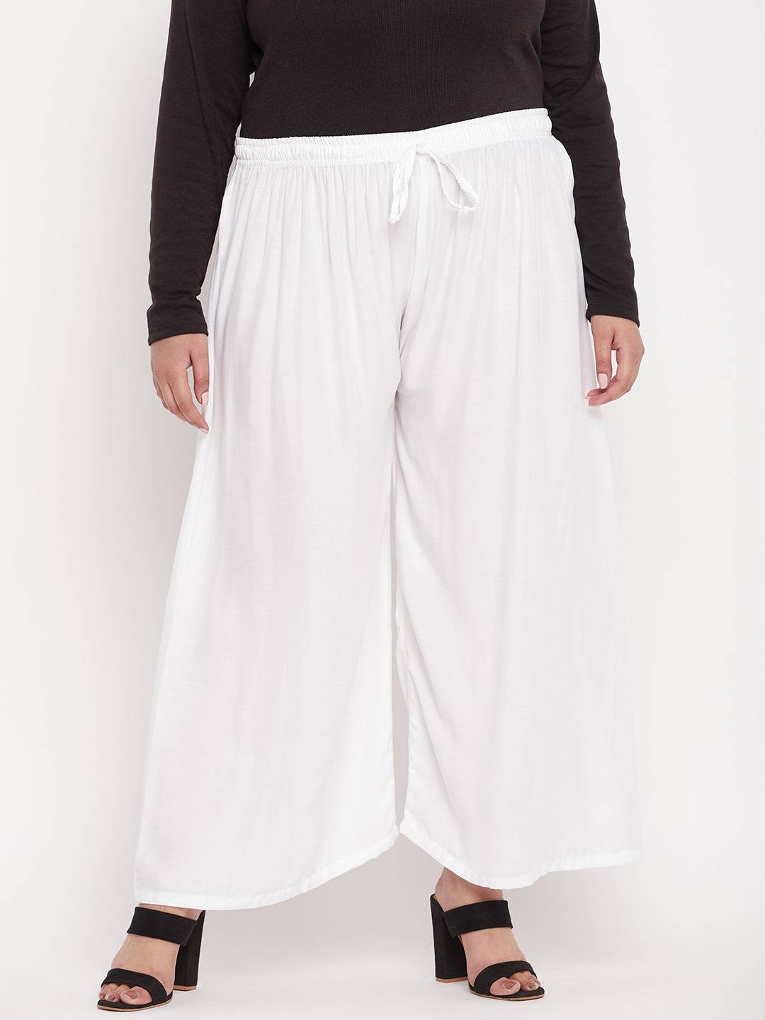 White solid rayon palazzo with elasticated waistband and drawstring.