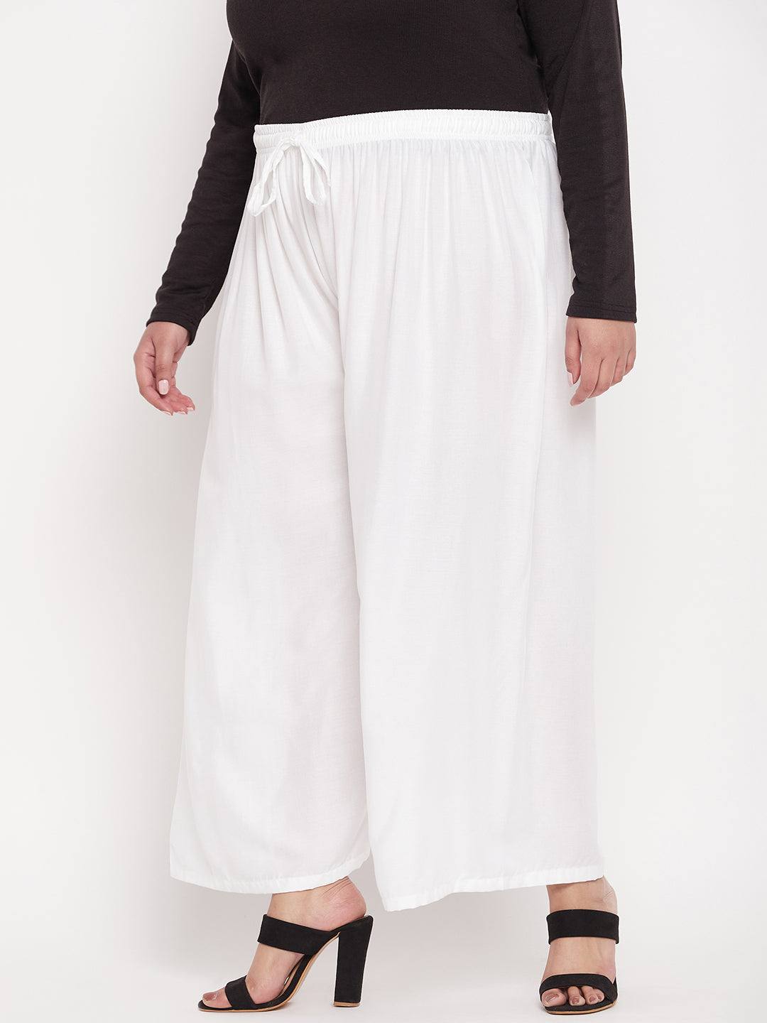 White solid rayon palazzo with elasticated waistband and drawstring.