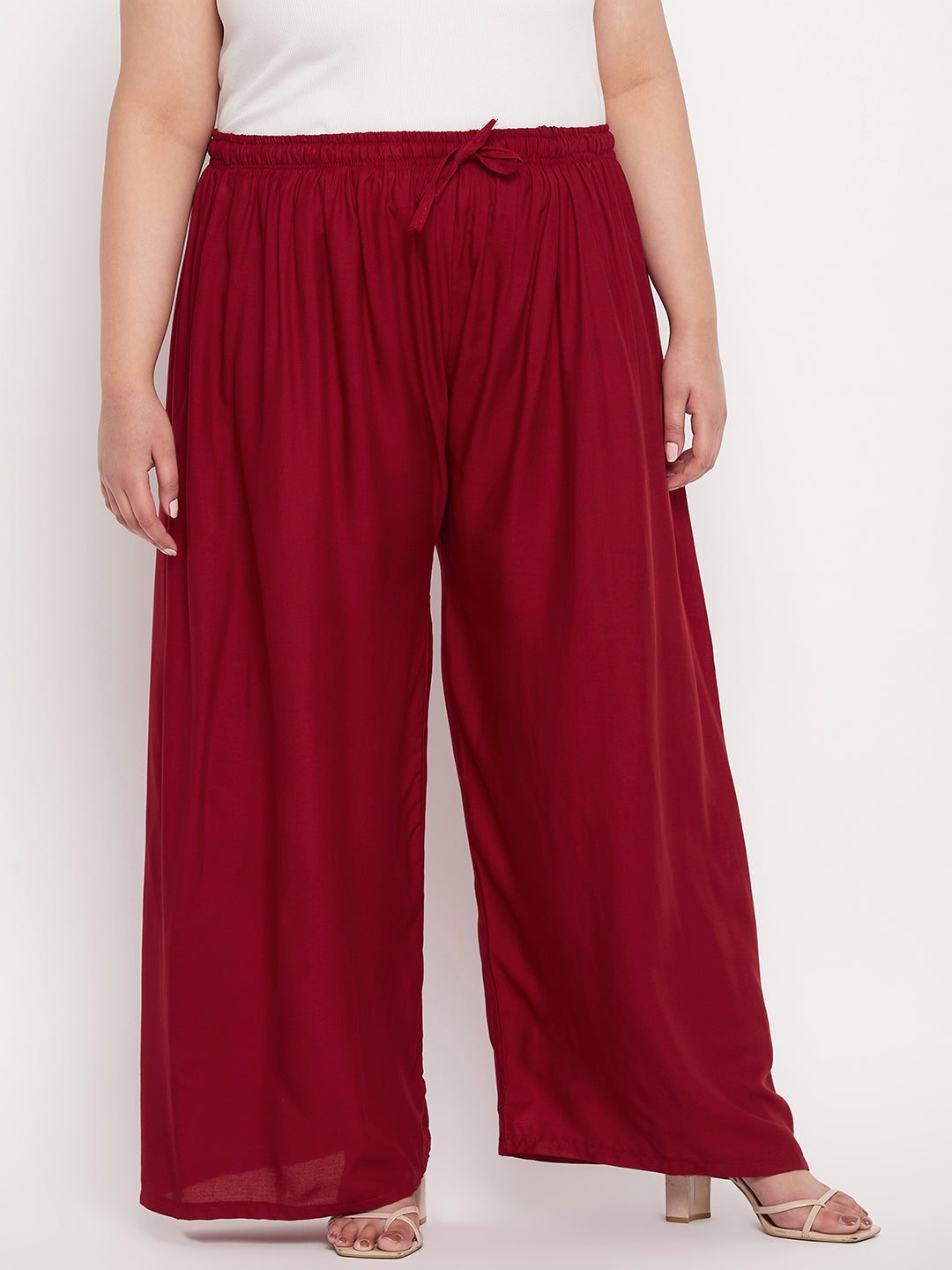 Maroon solid rayon palazzo with elasticated waistband and drawstring.