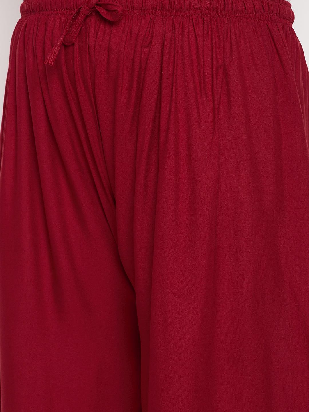 Maroon solid rayon palazzo with elasticated waistband and drawstring.