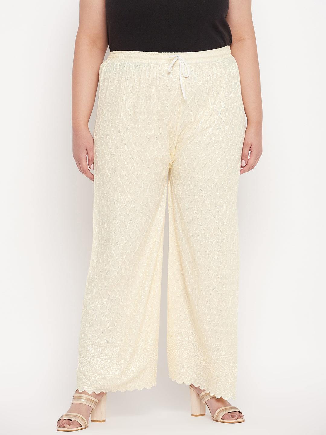 Cream embroidered rayon palazzo with elastic waistband and drawstring.