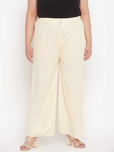 Cream embroidered rayon palazzo with elastic waistband and drawstring.