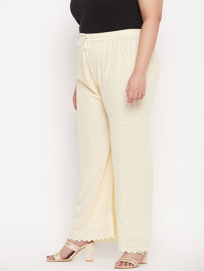 Cream embroidered rayon palazzo with Chikankari design and elasticated waistband.