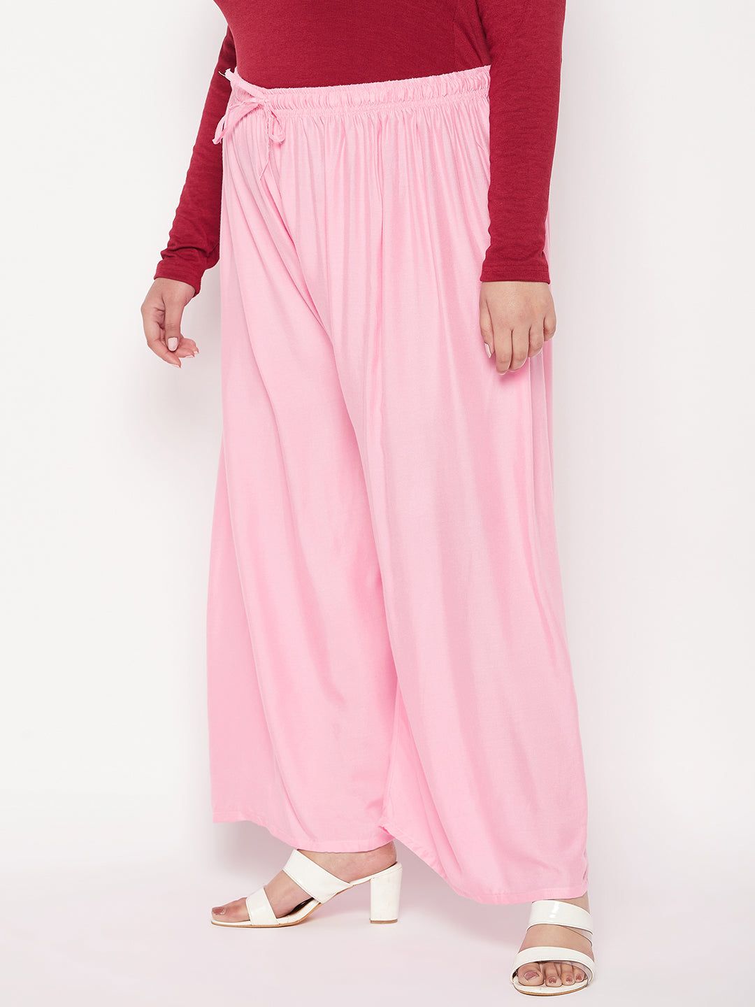 Baby pink solid rayon palazzo with elasticated waistband and drawstring.