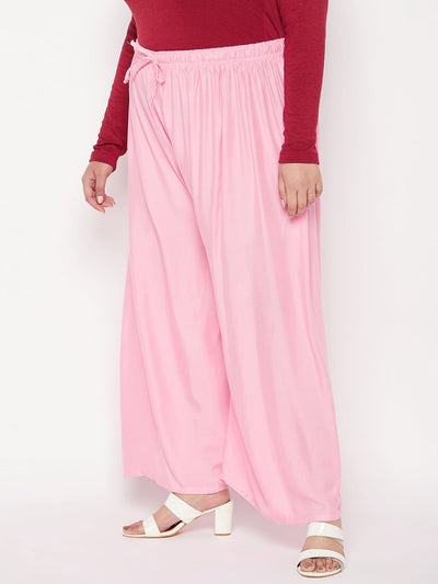 Baby pink solid rayon palazzo with elasticated waistband and drawstring.