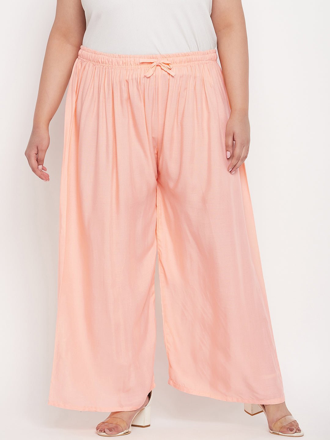 Peach solid rayon palazzo with elasticated waistband and drawstring.