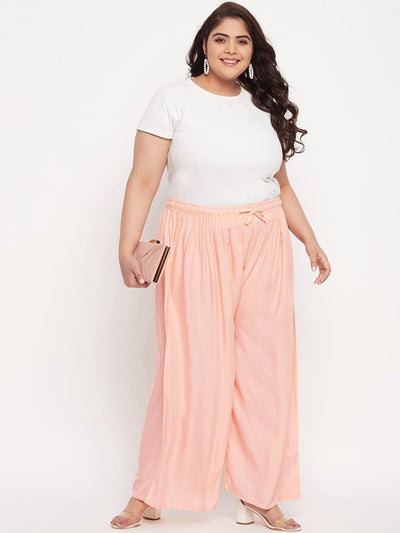 Peach solid rayon palazzo with elasticated waistband and drawstring.