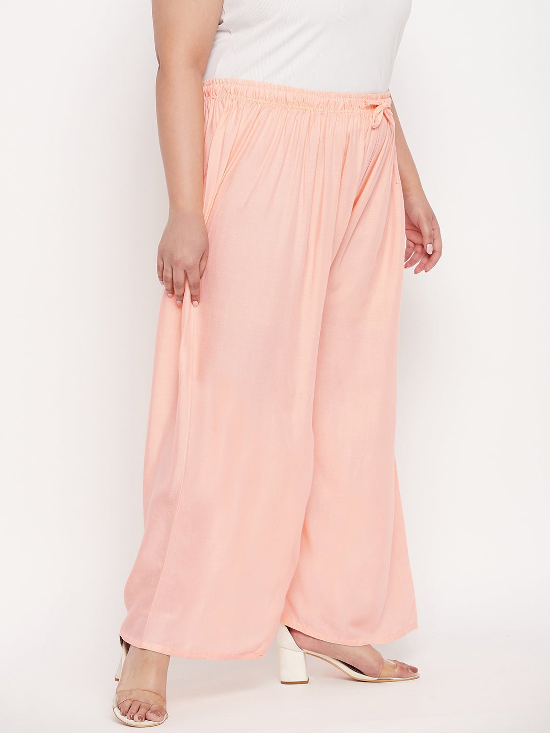 Peach solid rayon palazzo with elasticated waistband and drawstring.