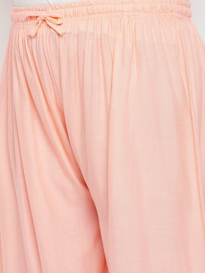 Peach solid rayon palazzo with elasticated waistband and drawstring.