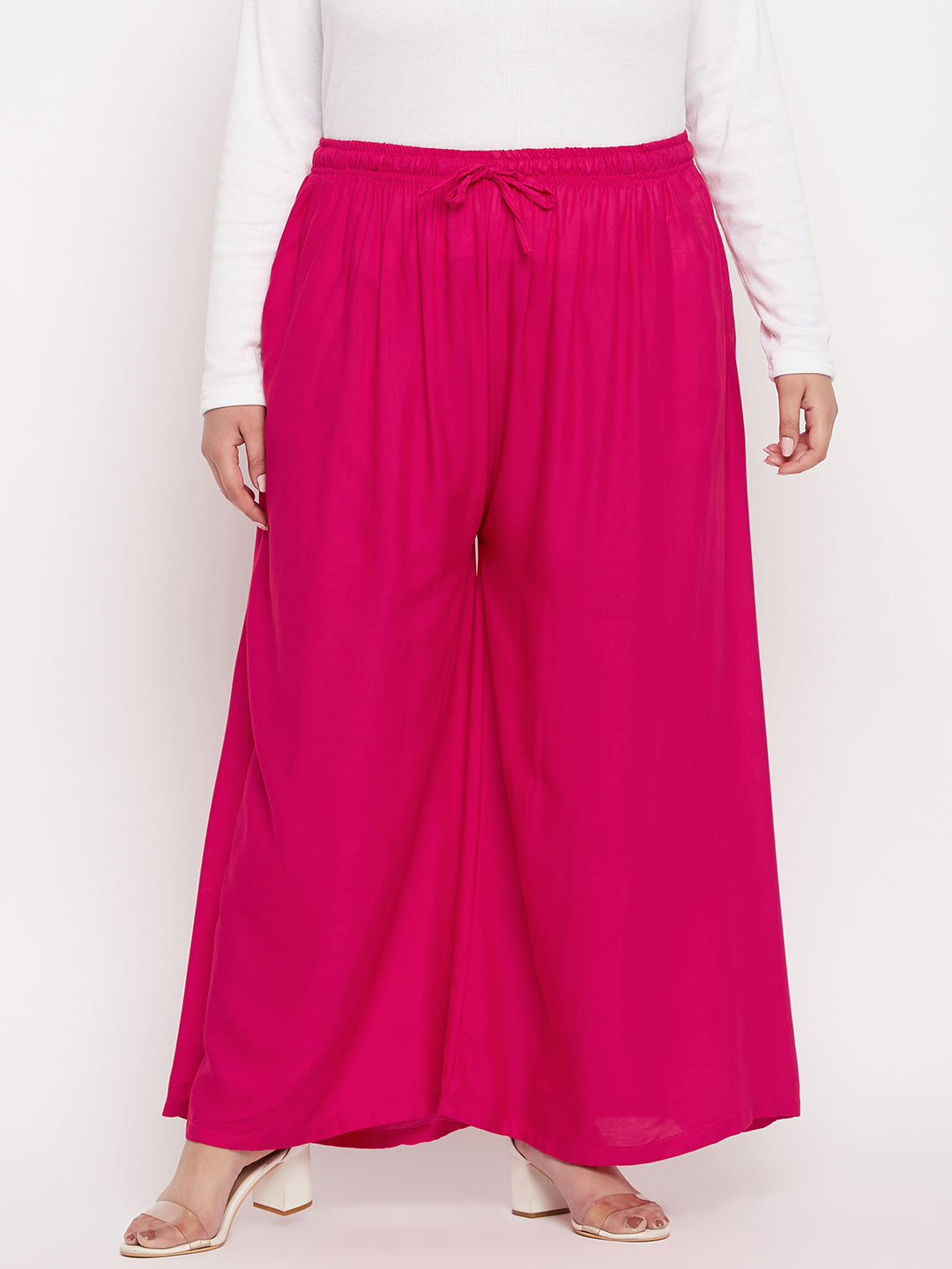 Magenta solid rayon jumbo sharara with elasticated waistband and drawstring.