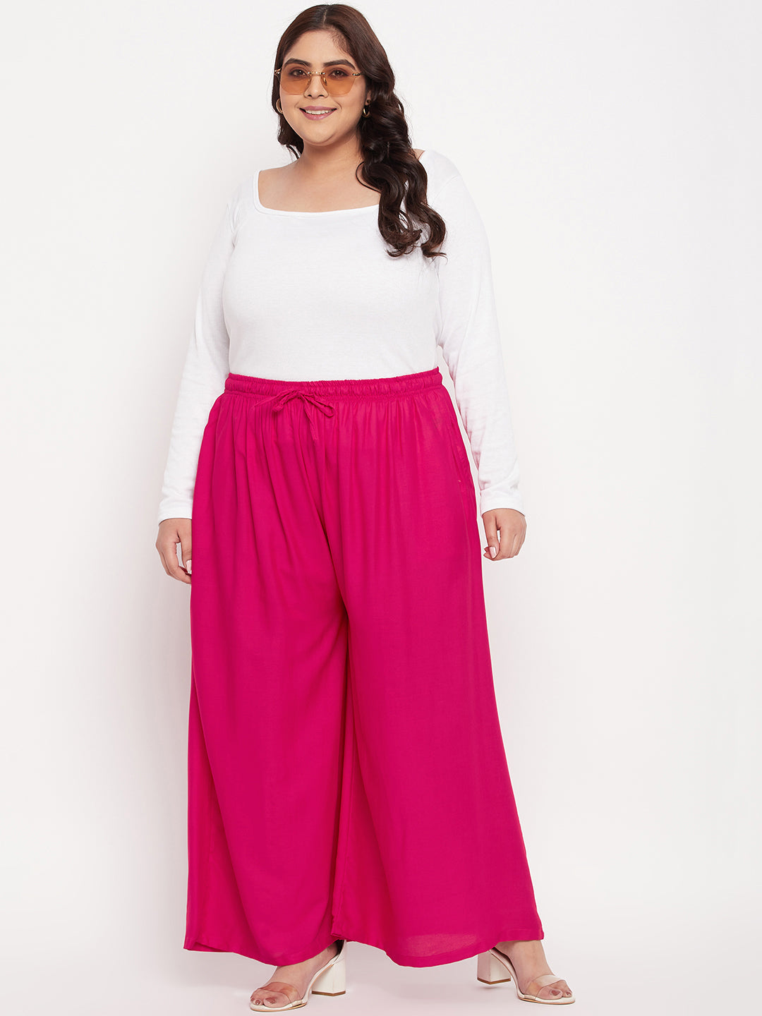 Magenta solid rayon jumbo sharara with elasticated waistband.