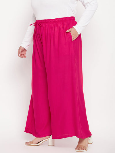 Magenta solid rayon jumbo sharara with elasticated waistband and drawstring.