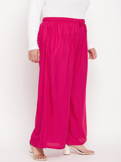 Magenta solid rayon jumbo sharara with elasticated waistband and drawstring.