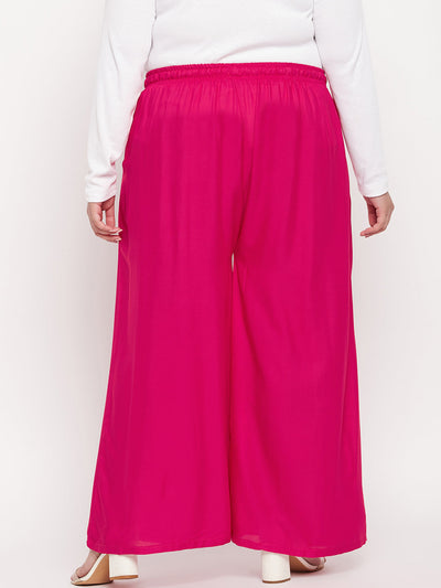 Magenta solid rayon jumbo sharara with elasticated waistband and drawstring.