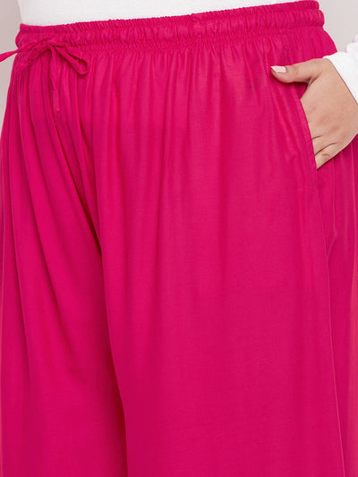 Magenta solid rayon jumbo sharara with elasticated waistband and drawstring.