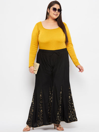 Black printed rayon flared sharara with elasticated waistband and drawstring.
