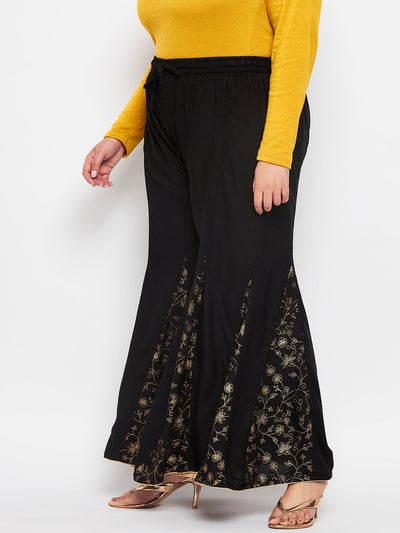 Black printed rayon flared sharara with elasticated waistband and drawstring.