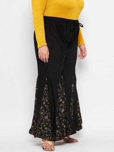 Black printed rayon flared sharara with elasticated waistband and drawstring.
