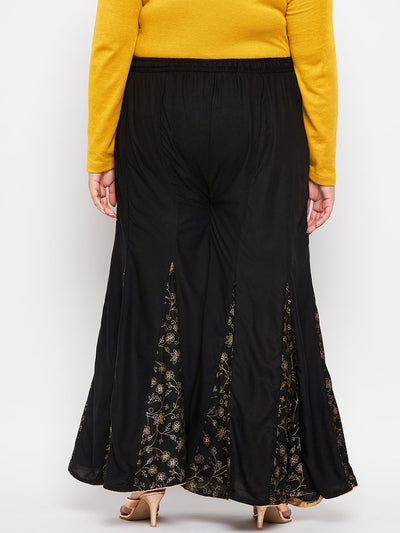 Black printed rayon flared sharara with elastic waistband and drawstring.