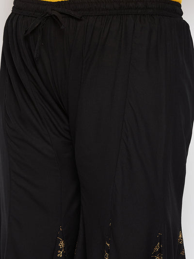 Black printed rayon flared sharara with elastic waistband and drawstring.