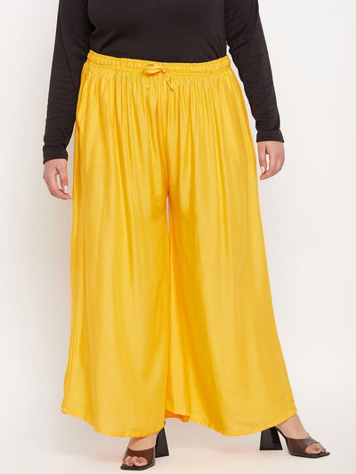 Yellow solid rayon jumbo sharara with elasticated waistband and drawstring.