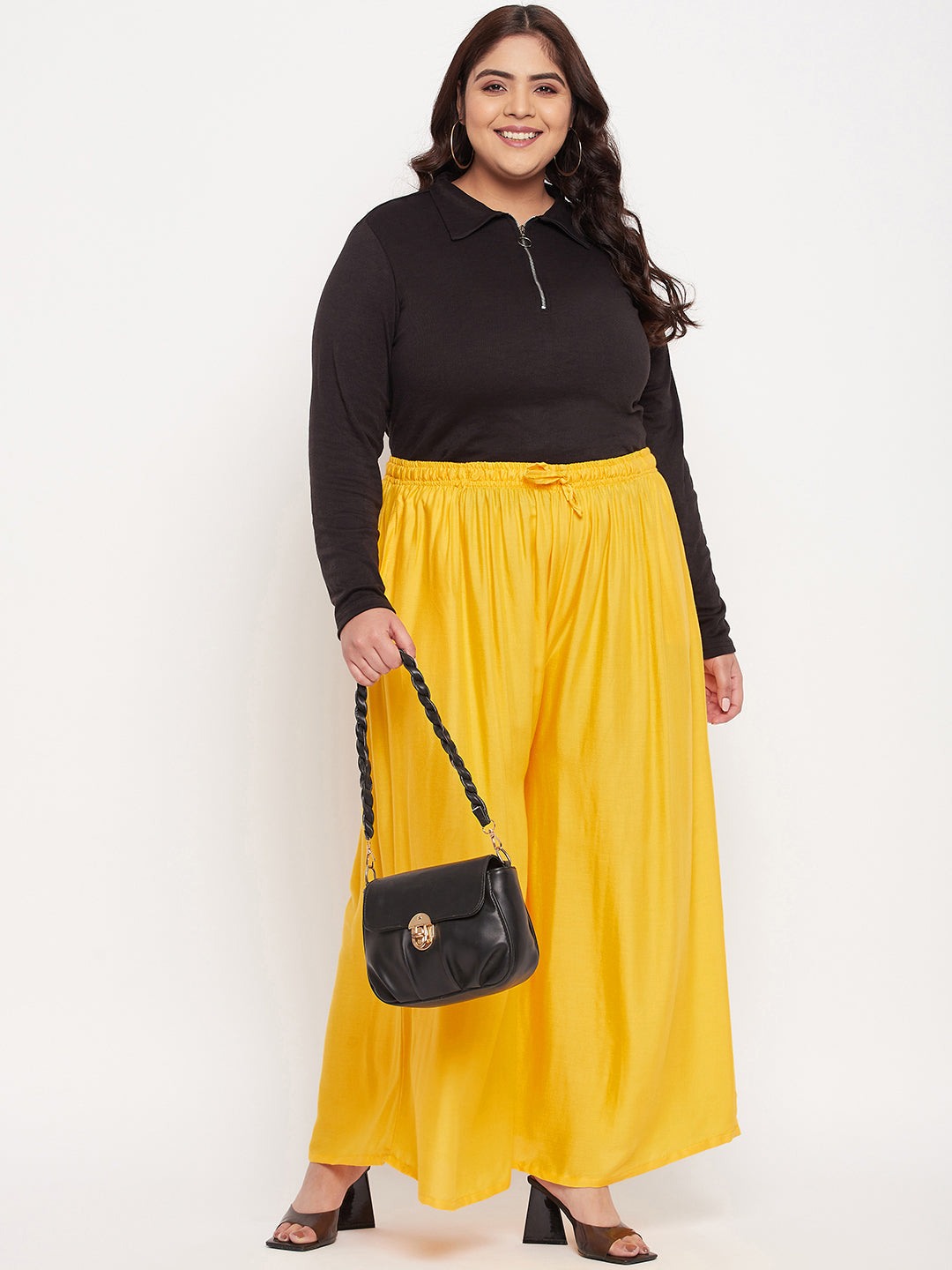 Yellow solid rayon jumbo sharara with elastic waistband and drawstring.