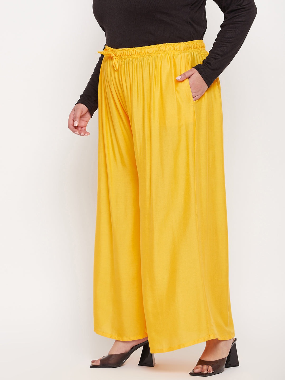 Yellow solid rayon jumbo sharara with elasticated waistband and drawstring.