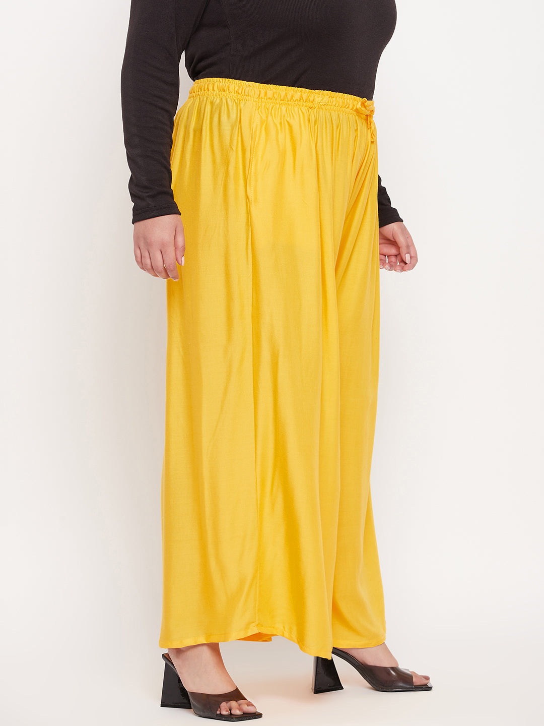 Yellow solid rayon jumbo sharara with elasticated waistband and drawstring.