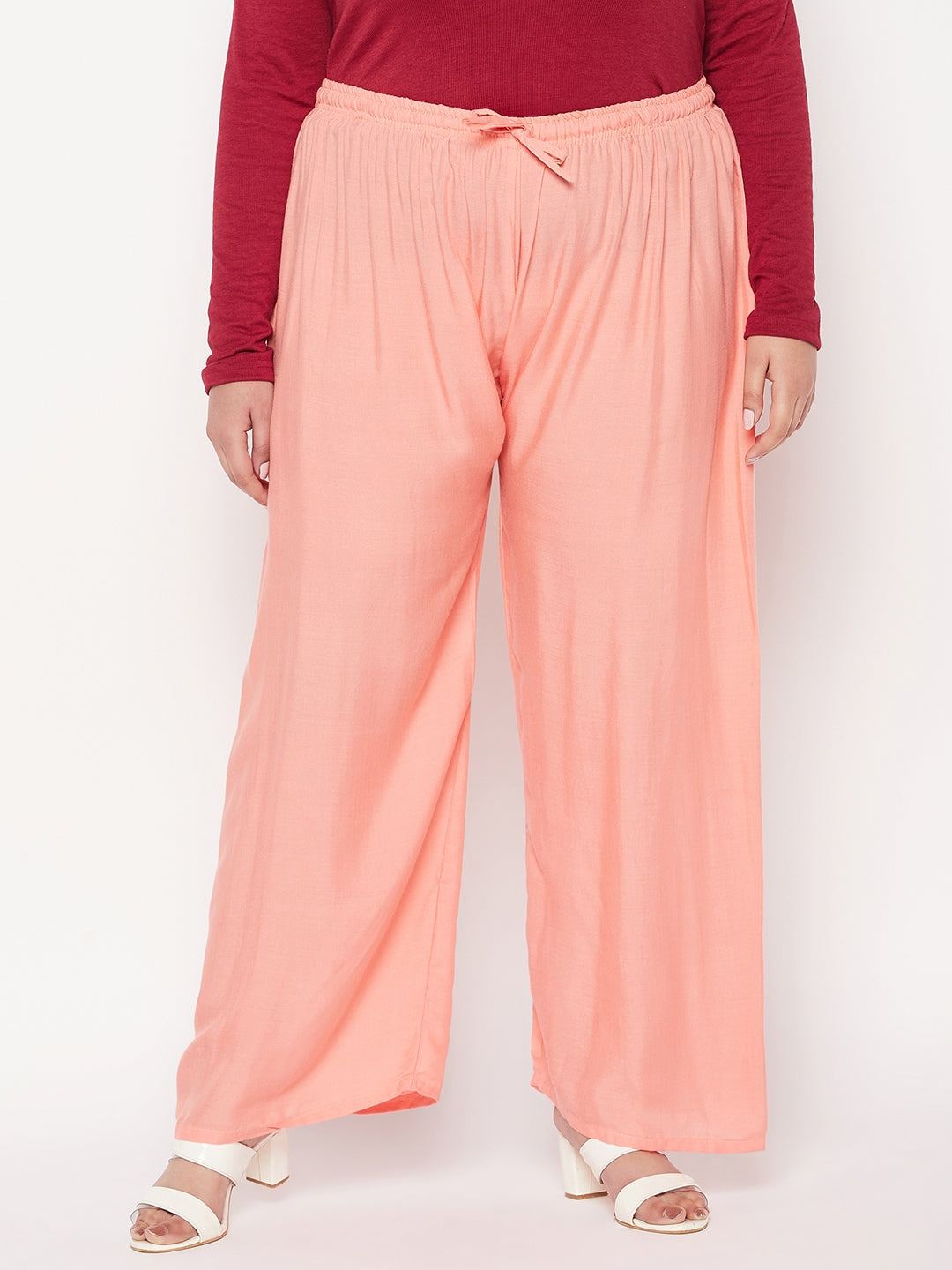 Dark peach solid rayon palazzo with elastic waistband and drawstring.
