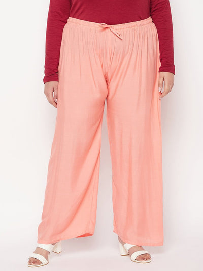 Dark peach solid rayon palazzo with elastic waistband and drawstring.