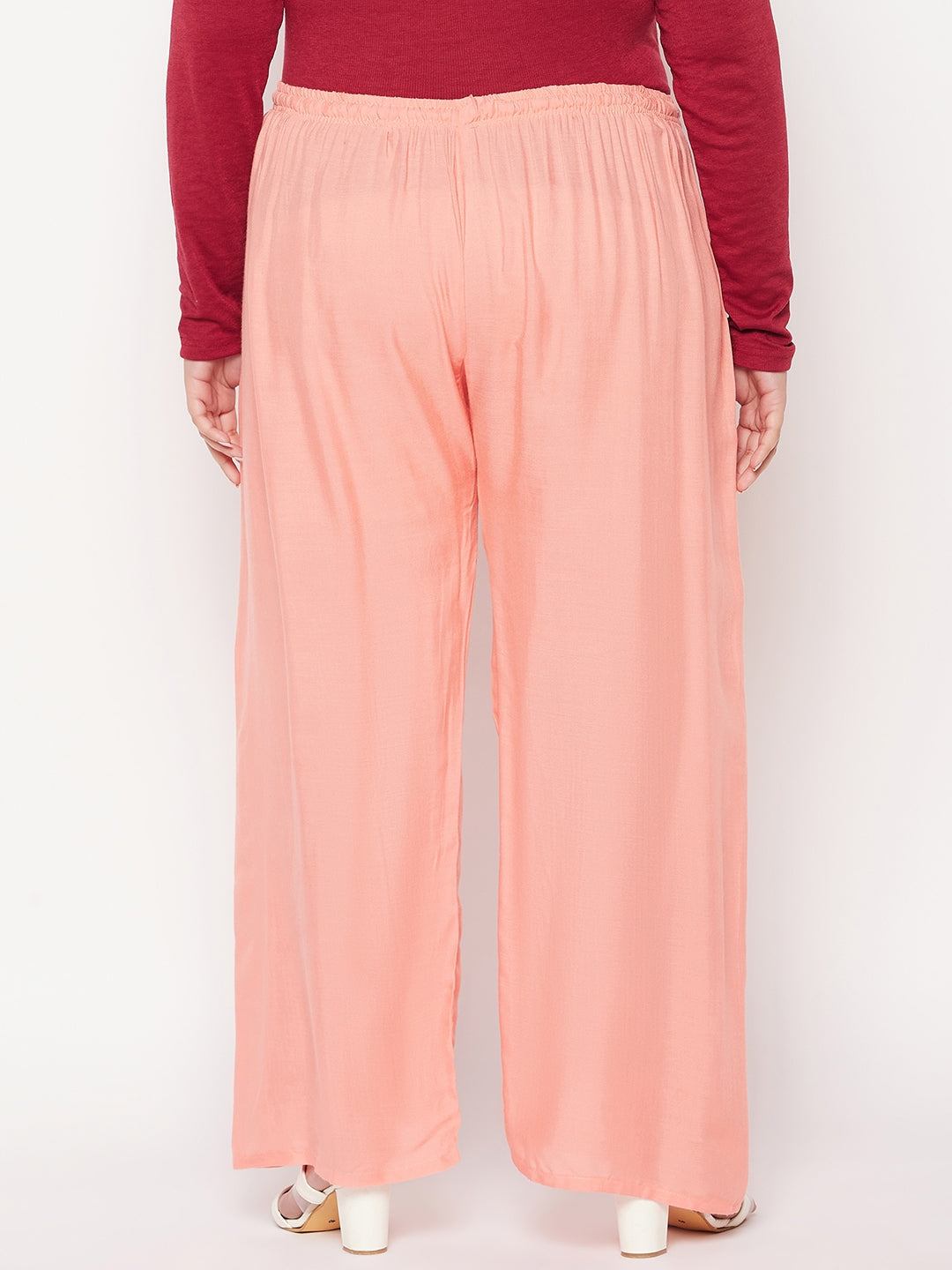 Dark peach solid rayon palazzo with elasticated waistband and drawstring.