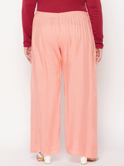 Dark peach solid rayon palazzo with elasticated waistband and drawstring.