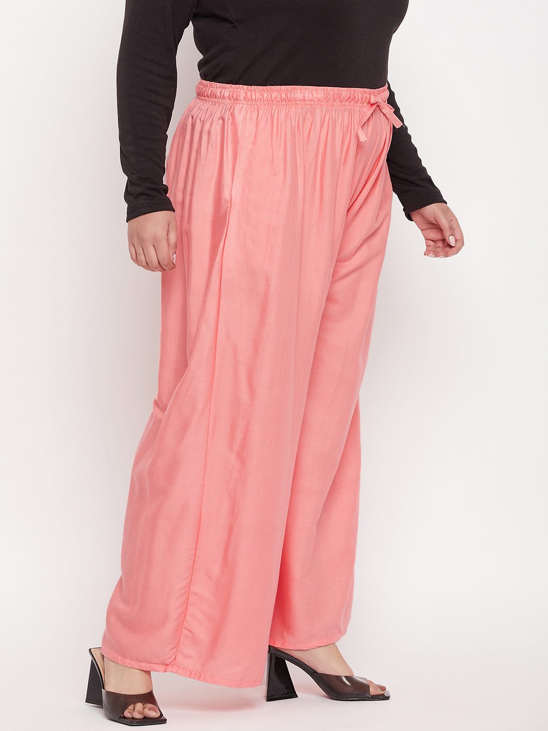 Dark peach solid rayon jumbo sharara with elasticated waistband and drawstring.