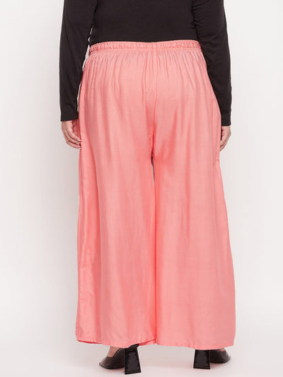 Dark peach solid rayon jumbo sharara with elasticated waistband and drawstring.