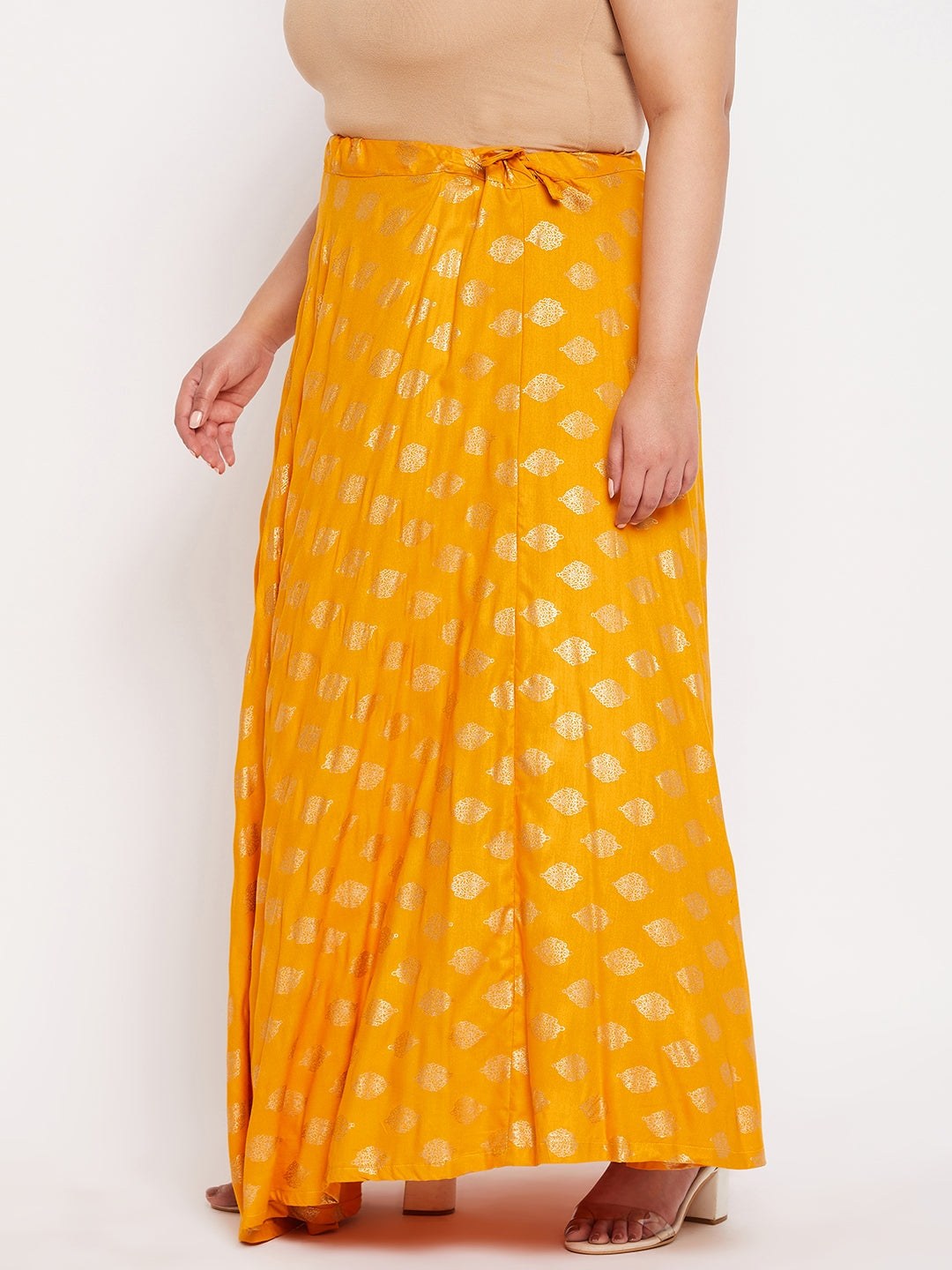 Mustard printed flared rayon skirt with drawstring waistband.