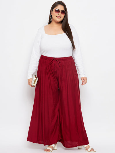Maroon solid rayon flared sharara with elasticated waistband and drawstring.