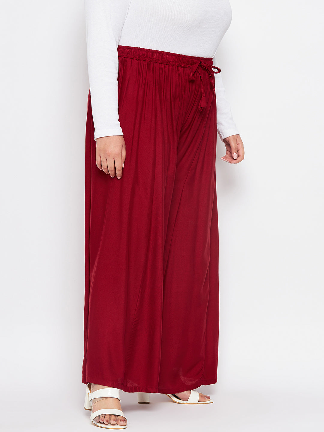 Maroon solid rayon flared sharara with elasticated waistband and drawstring.
