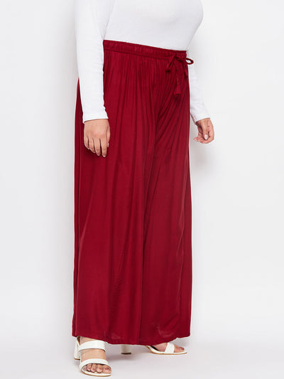 Maroon solid rayon flared sharara with elasticated waistband and drawstring.