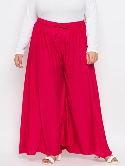 Magenta solid rayon flared sharara with elasticated waistband and drawstring.