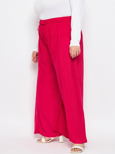 Magenta solid rayon flared sharara with elasticated waistband.