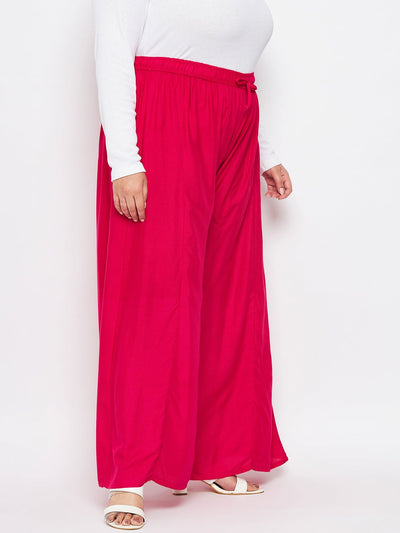 Magenta solid rayon flared sharara with elasticated waistband and drawstring.
