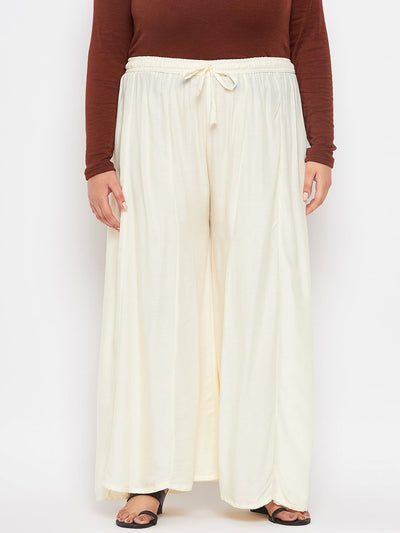 Cream solid rayon flared sharara with elastic waistband and drawstring.