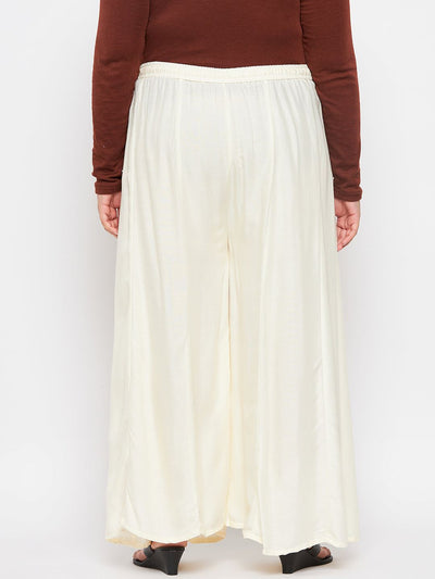 Cream solid rayon flared sharara with elasticated waistband and drawstring.